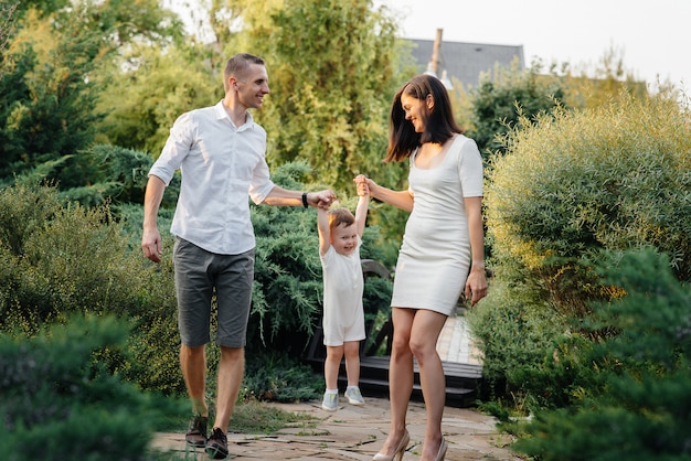 Happy family with their son walking in the Park at sunset. Happiness. Love