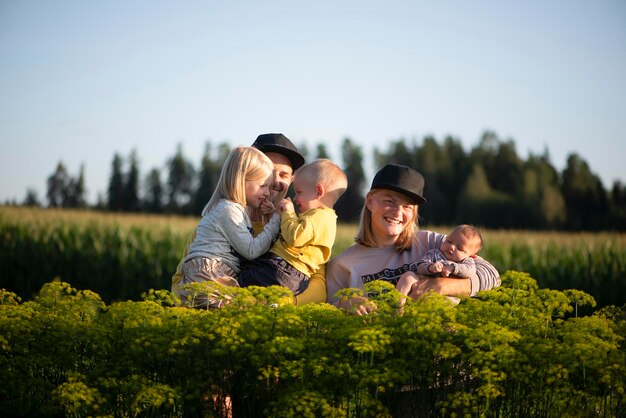 Photo happy family with three children outdoors garden on sunny day evening