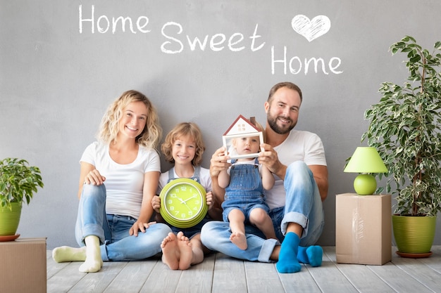 Happy family with two kids playing into new home