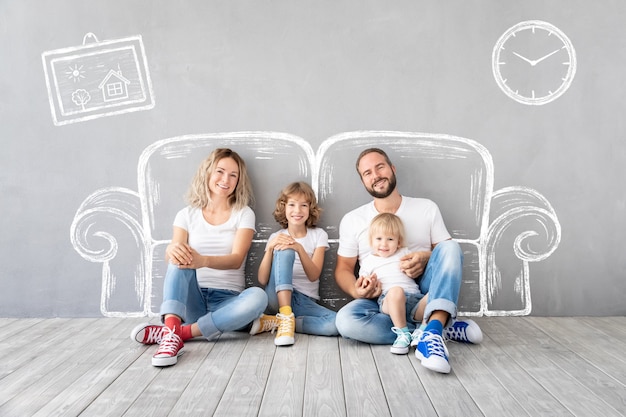 Happy family with two kids playing into new home