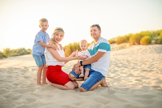 Happy family with a two small son on the beach Vacation tourism concept Anapa Russia