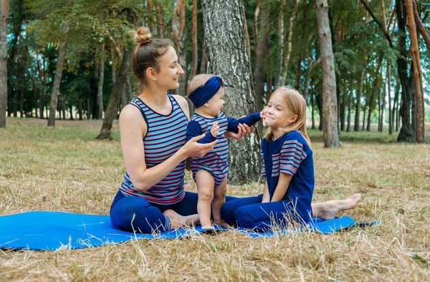 Happy family young mother embrace cute little baby children daughters smiling parent mum and two