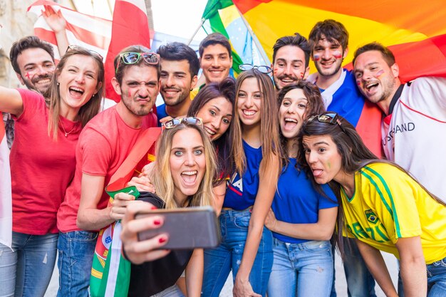 Happy fans supporters taking a selfie all together