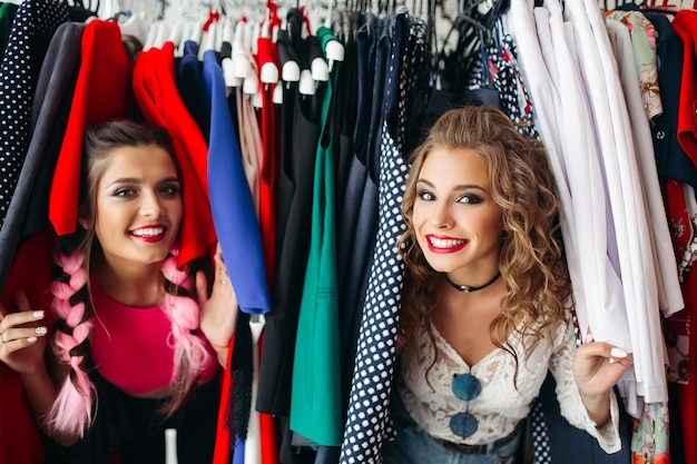 Happy fashionable girls having fun together,spending time at store.