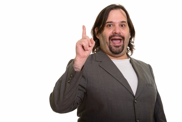 Happy fat Caucasian businessman smiling and pointing finger up isolated on white