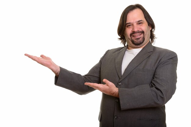 Happy fat Caucasian businessman smiling showing something isolated on white