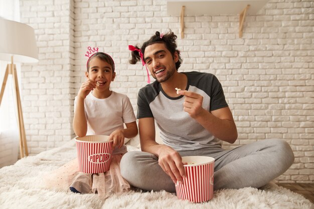 Happy Father and Daughter are Sitting on a Couch