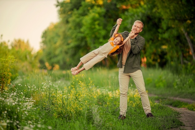 happy father and daughter having fun on a walk in the park