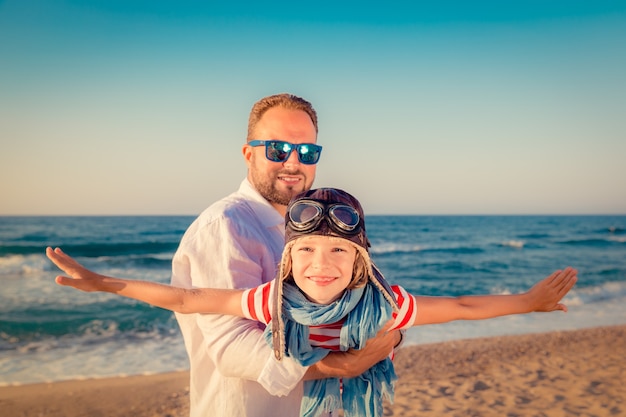 happy father and daugther playing and having fun on summer vacation at the beach