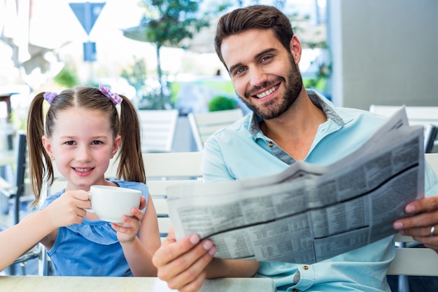 Happy father and his daughter having breakfast together