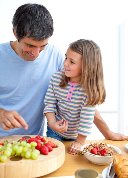 Happy father and his daughter having breakfast