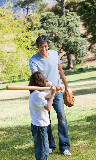 Happy father and his son playing baseball 