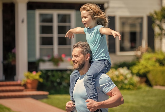 Happy father hold son on hands outdoor carefree