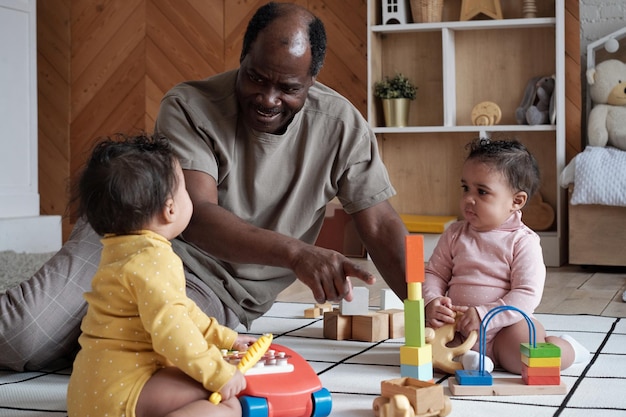 Happy father playing with daughters