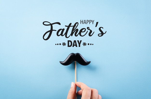 Happy Father's Day concept on bright blue paper