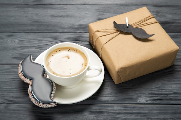 Happy father's day concept. Plate with delicious cookies and a gift