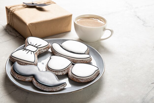 Happy Father's Day concept. Tasty cookies and cup of coffee on wooden background