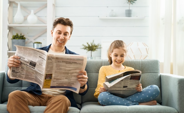 Happy father's day Father and daughter reading newspaper