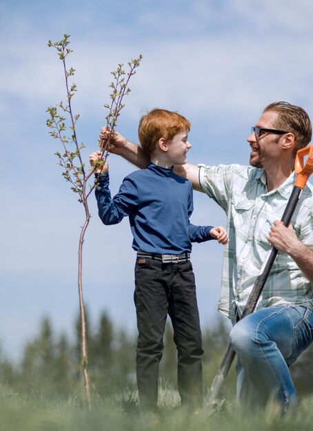 Happy father and son planted a tree together