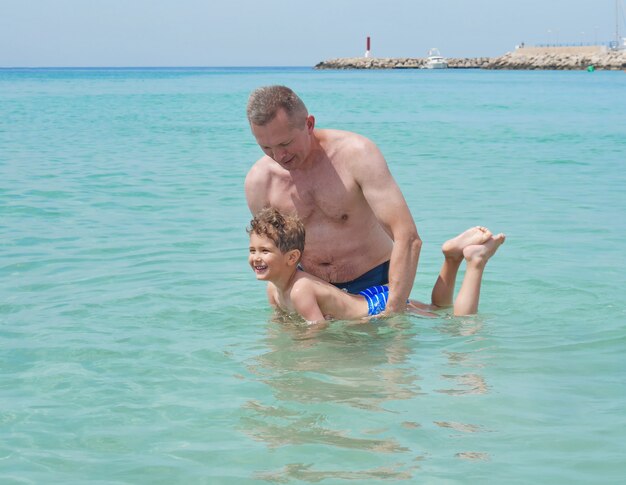 Happy father and son playing in the water