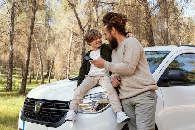 Happy father and son using mobile