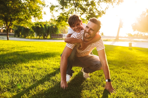 Happy father spending time with his little son at the park