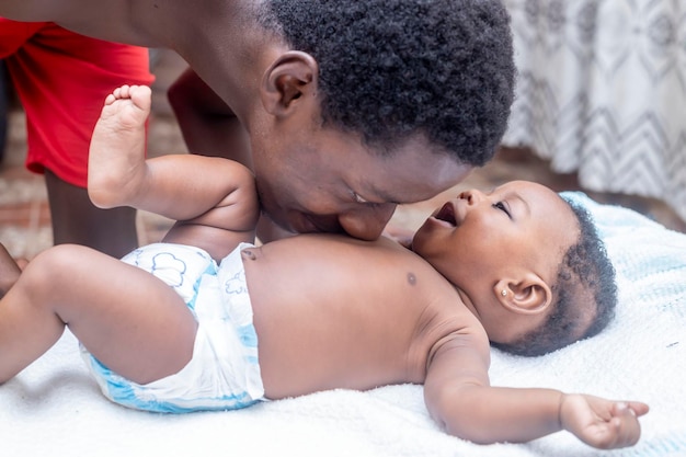 A happy father spends time with his baby on the couch in his living room