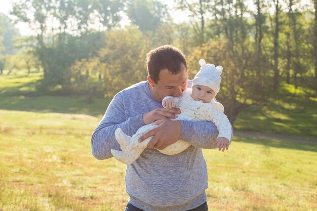 Happy father with the child in the field