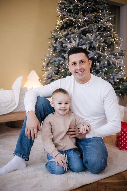 Happy father with his son playing home during winter holidays Christmas is coming