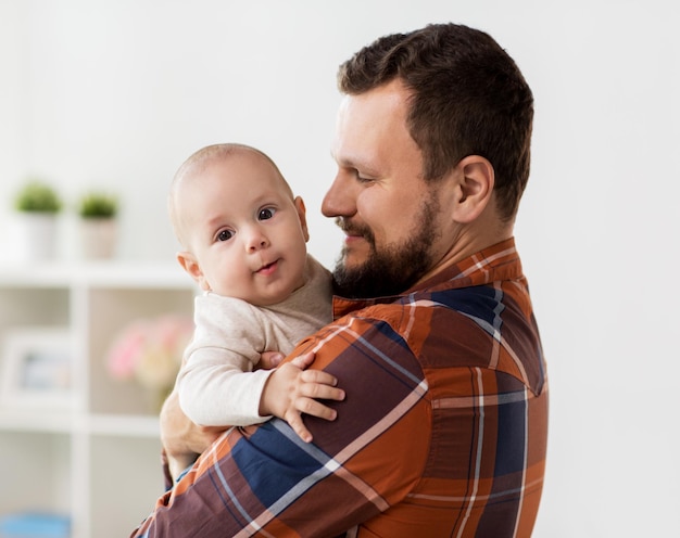 happy father with little baby boy at home