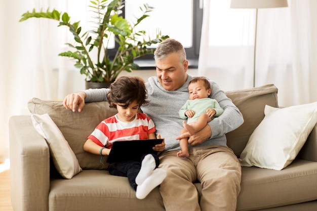 happy father with preteen and baby son at home