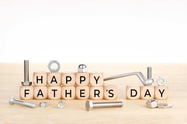 Happy fathers day concept. Wooden blocks with text on table with wrench, nuts and screws. Copy space. 