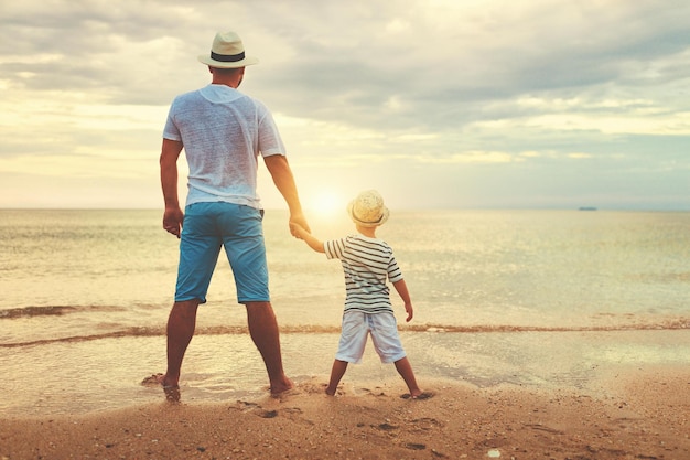 Happy fathers day family dad and child son at sea beach