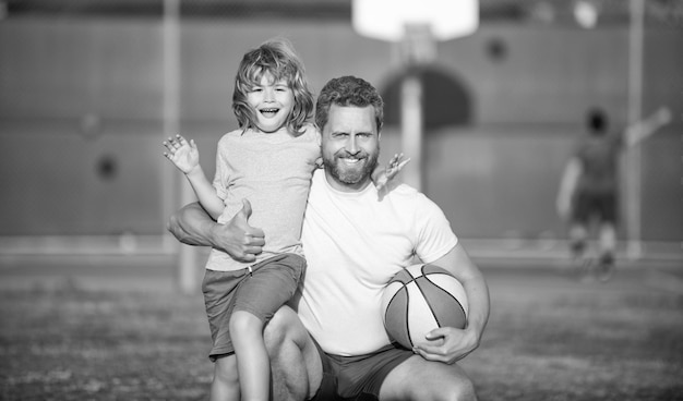 Happy fathers day family portrait dad and kid boy hold sport ball child play basketball
