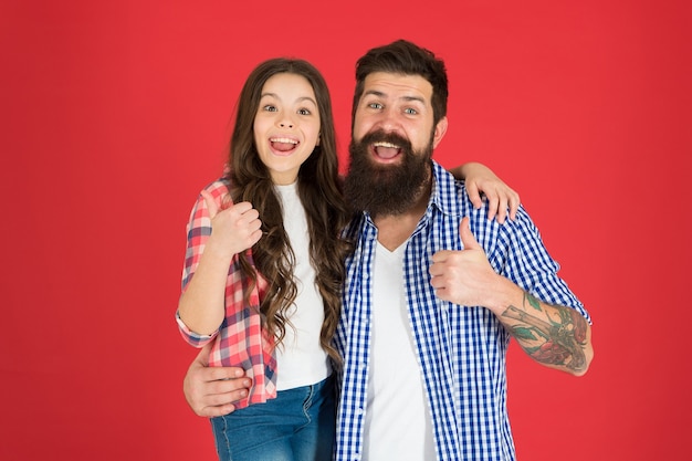 Happy fathers day Father and daughter hug on red background Child and father best friends