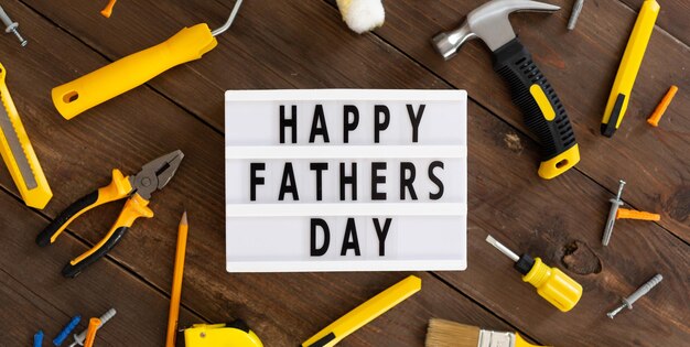 Happy Fathers Day Father's lightbox message with tools on wood background Greeting card concept