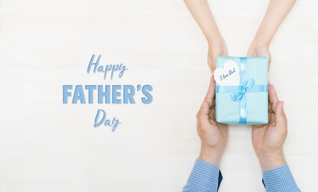 Happy fathers day Greeting card Gift in the hands of daughter and father