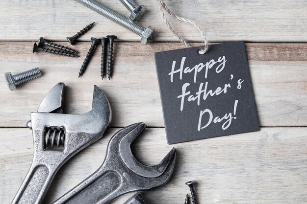 Happy fathers day greeting card old work tools on a gray wooden background