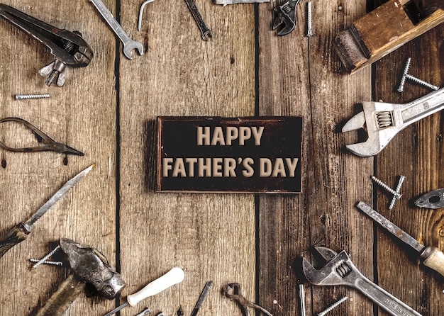 Happy Fathers DaySet of metal tools in the workshop on an old rustic wooden background