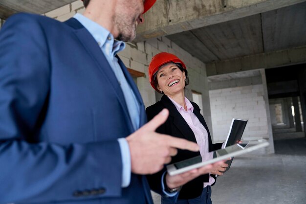 Happy female architect looking at colleague