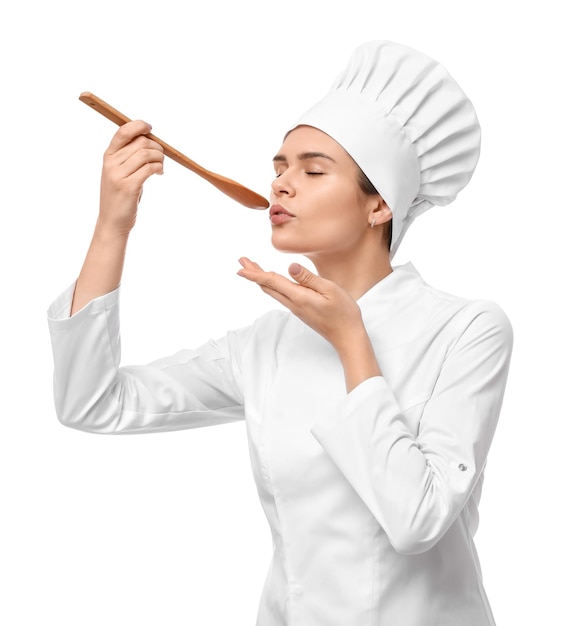 Happy female chef tasting something on white background