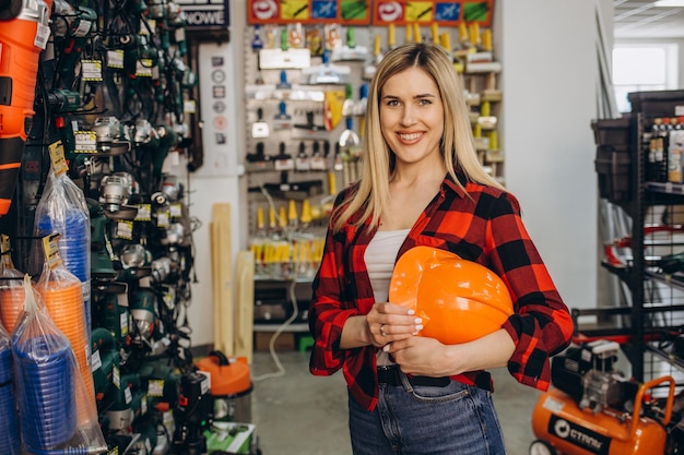 Happy female customer shopping in hardware store