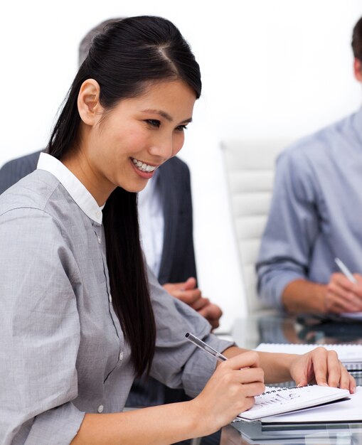 Happy female executive studying a document 