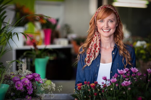 Happy female florist in flower shop