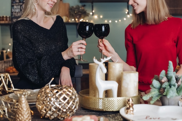 Happy female friends celebrating Christmas or New Year eve party