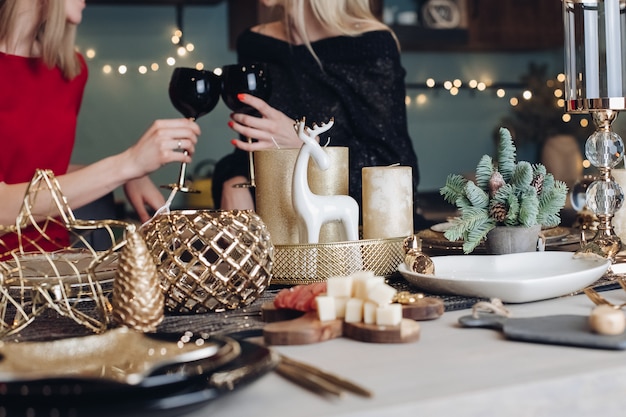 Happy female friends celebrating Christmas or New Year eve party