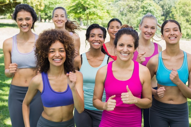 Happy female friends jogging in park