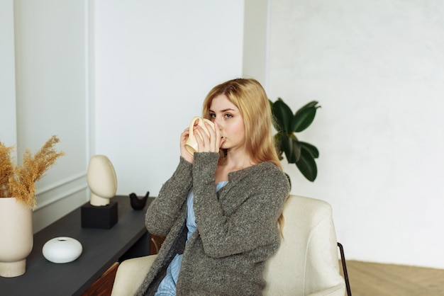 Happy female holding cup of coffee