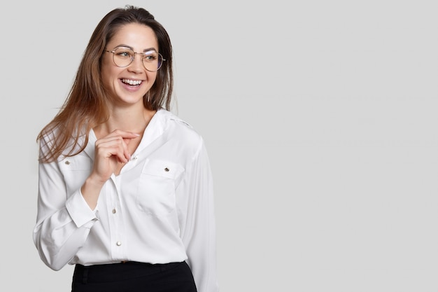 Happy female secretary dressed in black and white clothes