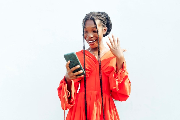 Happy Female Teenage Adult in Red Dress Looking Mobile Phone